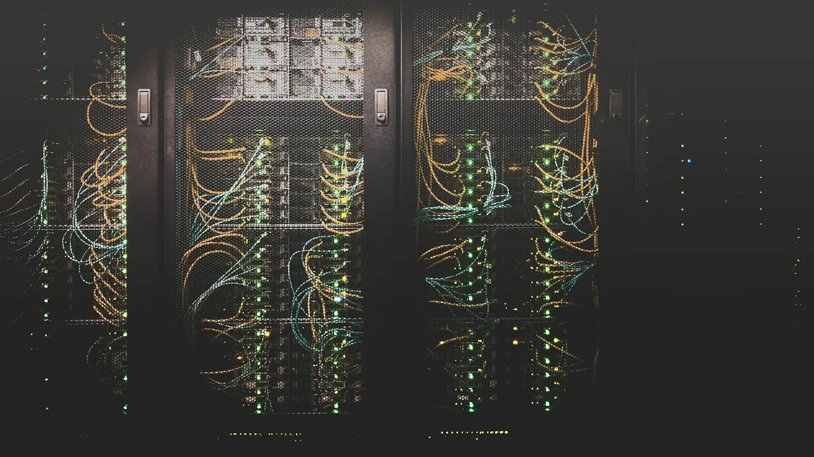 Rows of neatly cabled servers glowing in a dark rack