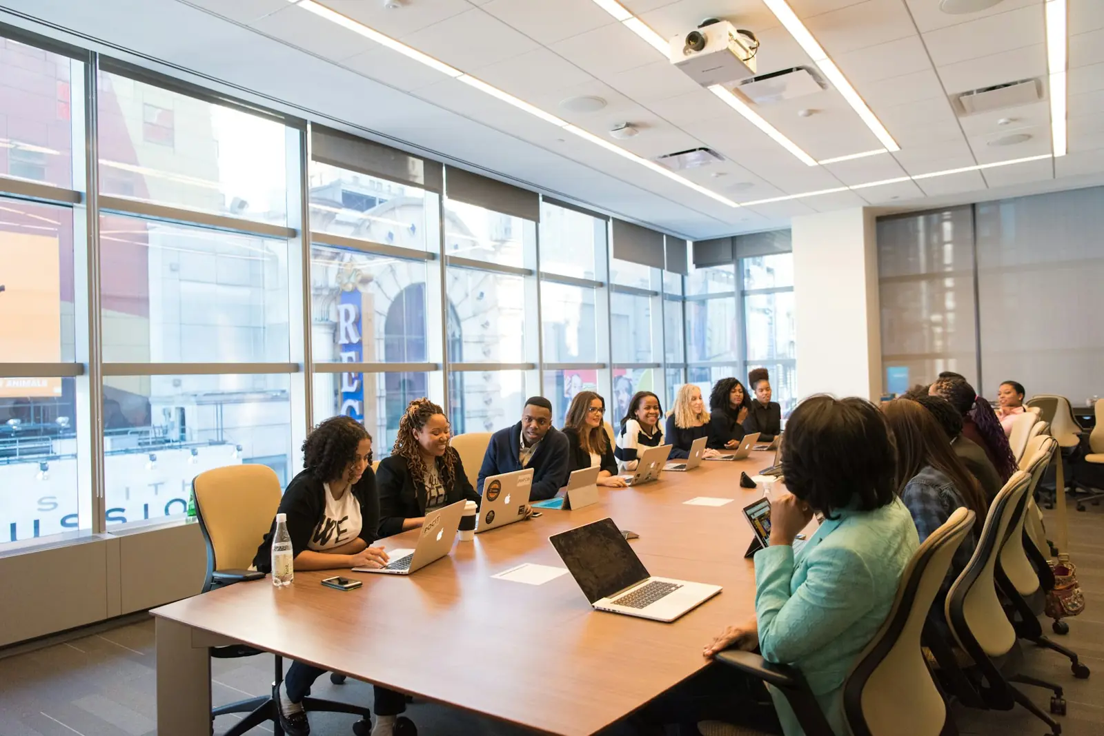 A team meeting around a long table in a bright office